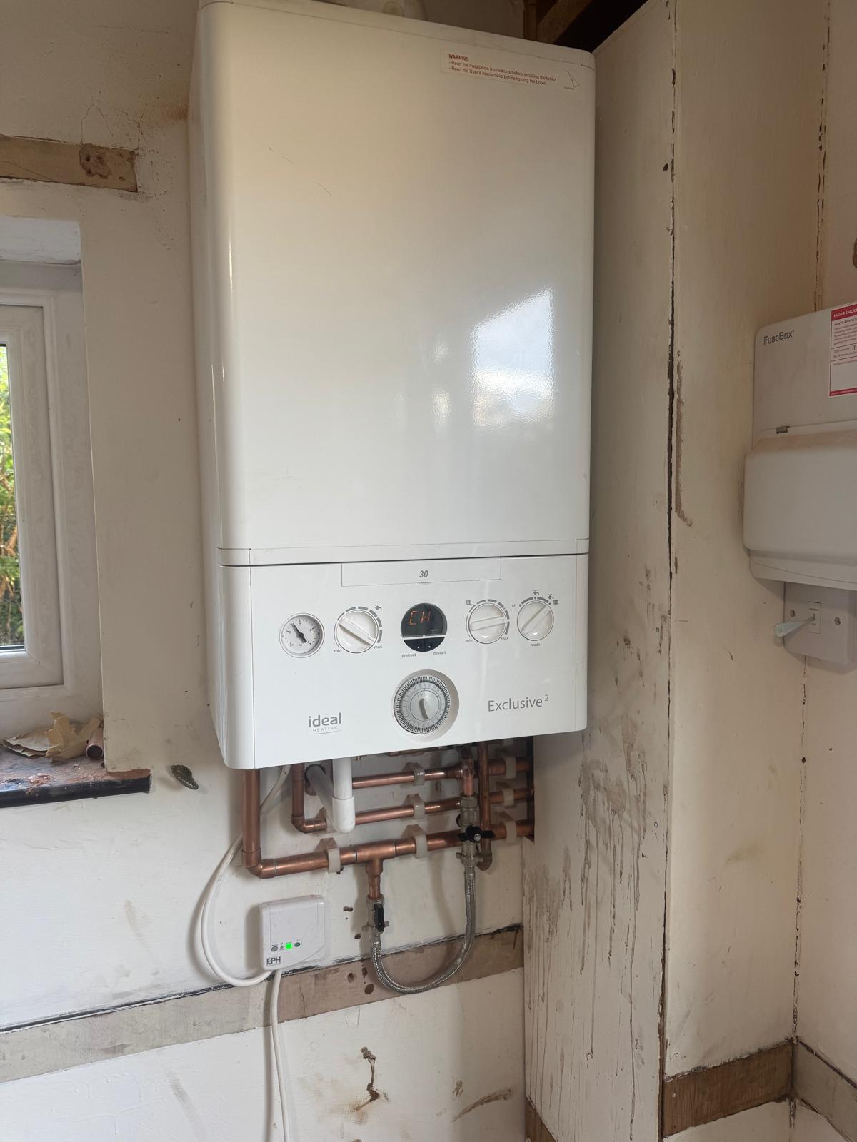 Ideal Exclusive 2 combi boiler with neat copper pipework installed by Apex Gas